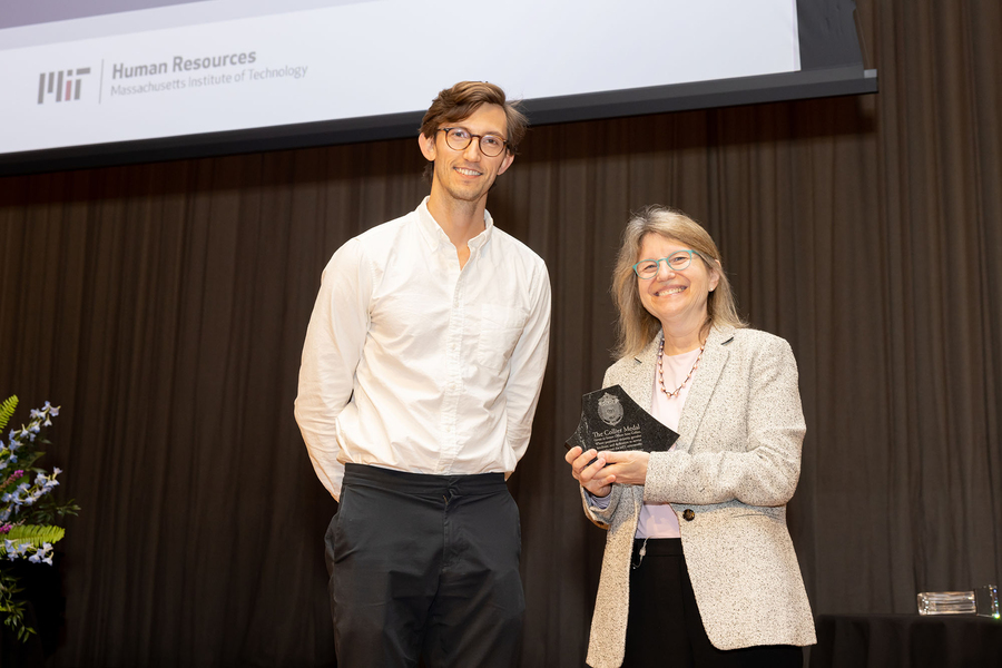 Graduate student Martin Nisser receiving the Collier Award from MIT President Sally Kornbluth on stage in Kresge Auditorium.