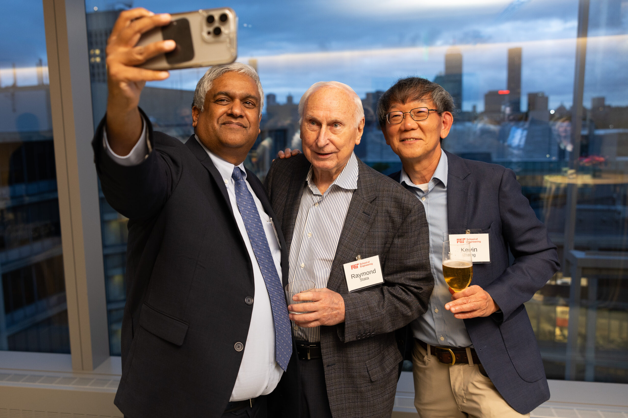 Anantha Chandrakasan takes a selfie with event attendees.